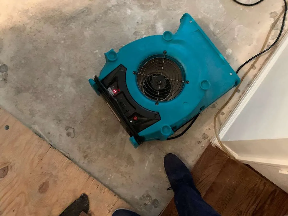 Air mover drying subfloor during Leak Detection & Repair in Box Elder